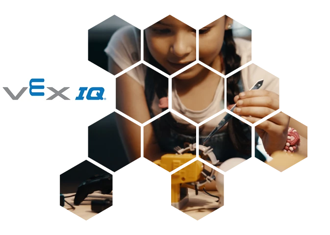 Estudiantes aprendiendo robótica con VEX IQ en una mesa de trabajo