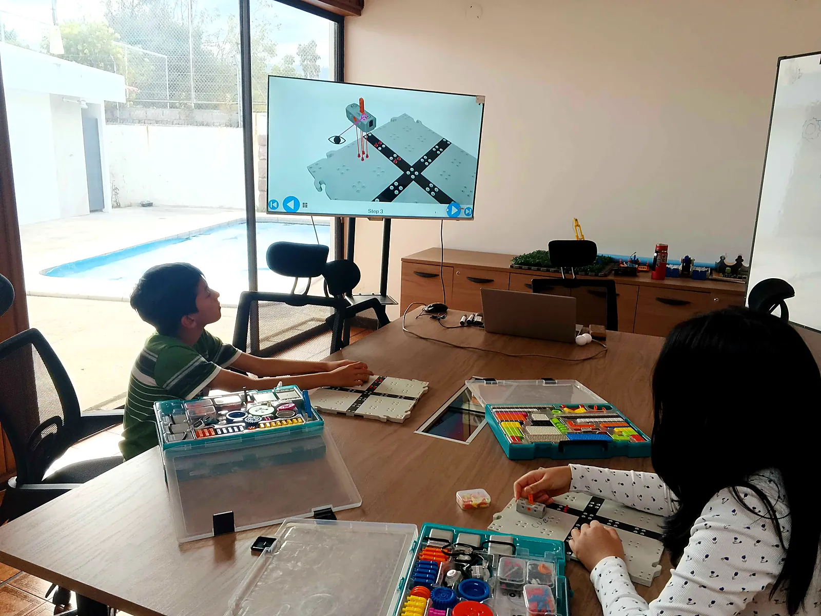 Niños armando robots VEX GO en una clase de robótica en Ecuador
