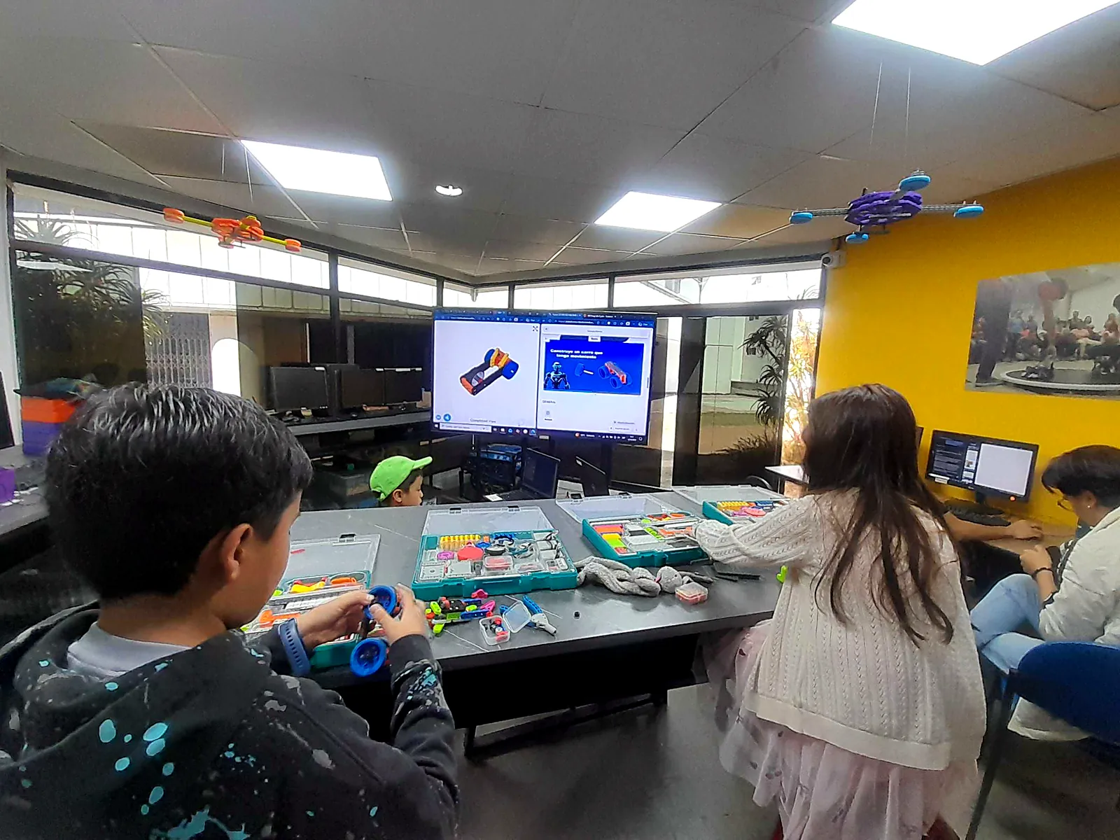 Mentora guiando a niños en un laboratorio de robótica en Ecuador